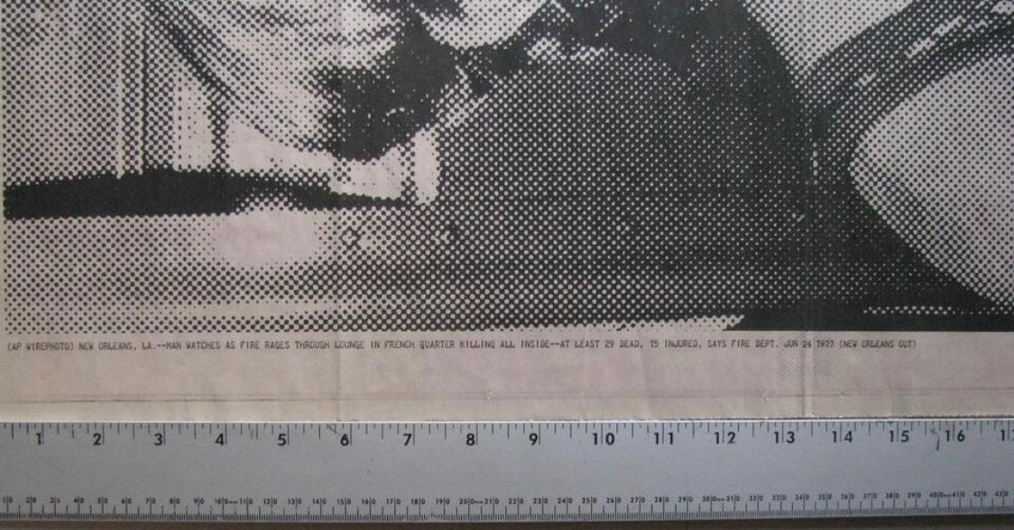 Black and white halftone printing on newsprint with a ruler along the bottom edge showing measurement scale.