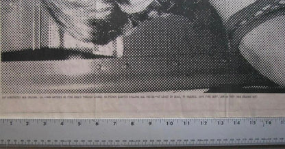 Black and white halftone printing on newsprint with a ruler along the bottom edge showing measurement scale.