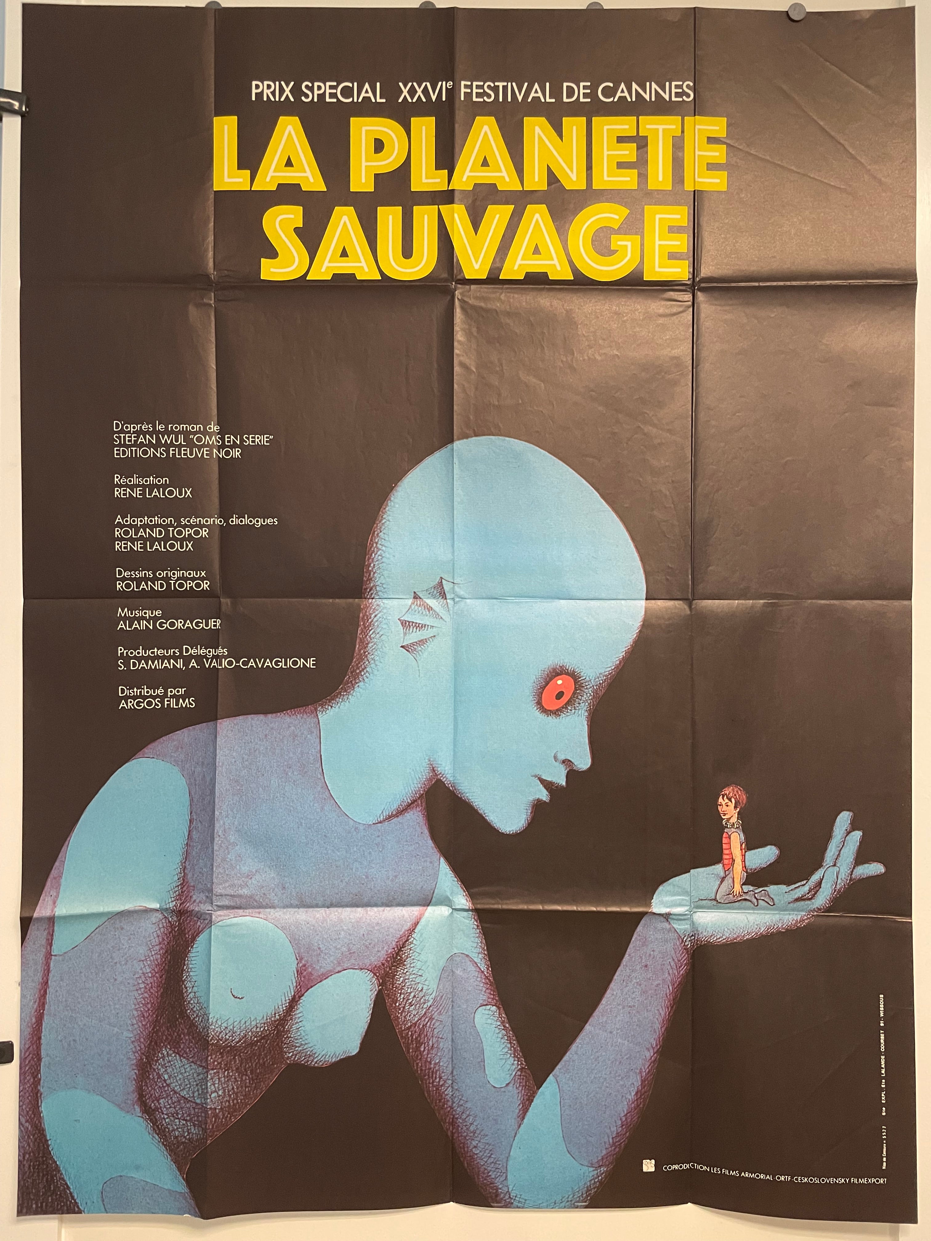 Vintage French film poster for 'La Planet Sauvage' featuring a large blue-skinned alien character enslaving a smaller, human-like character. The poster includes credits and information in French.