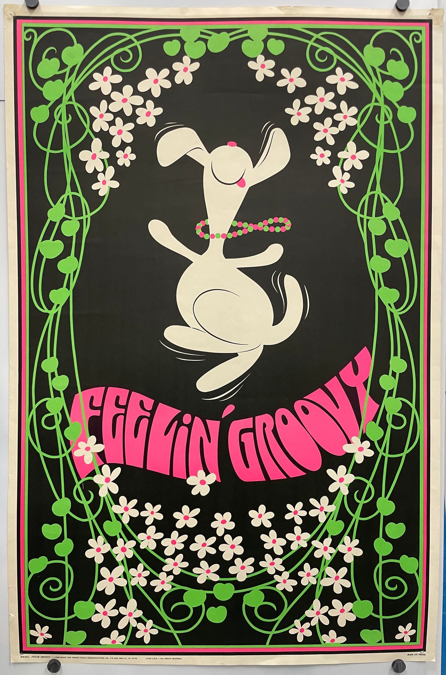 FEELIN' GROOVY ( title across the bottom) fun and lively vintage lithographic commercial poster. Image of a dancing Snoopy wearing a colorful beaded necklace, surrounded by flowers.
