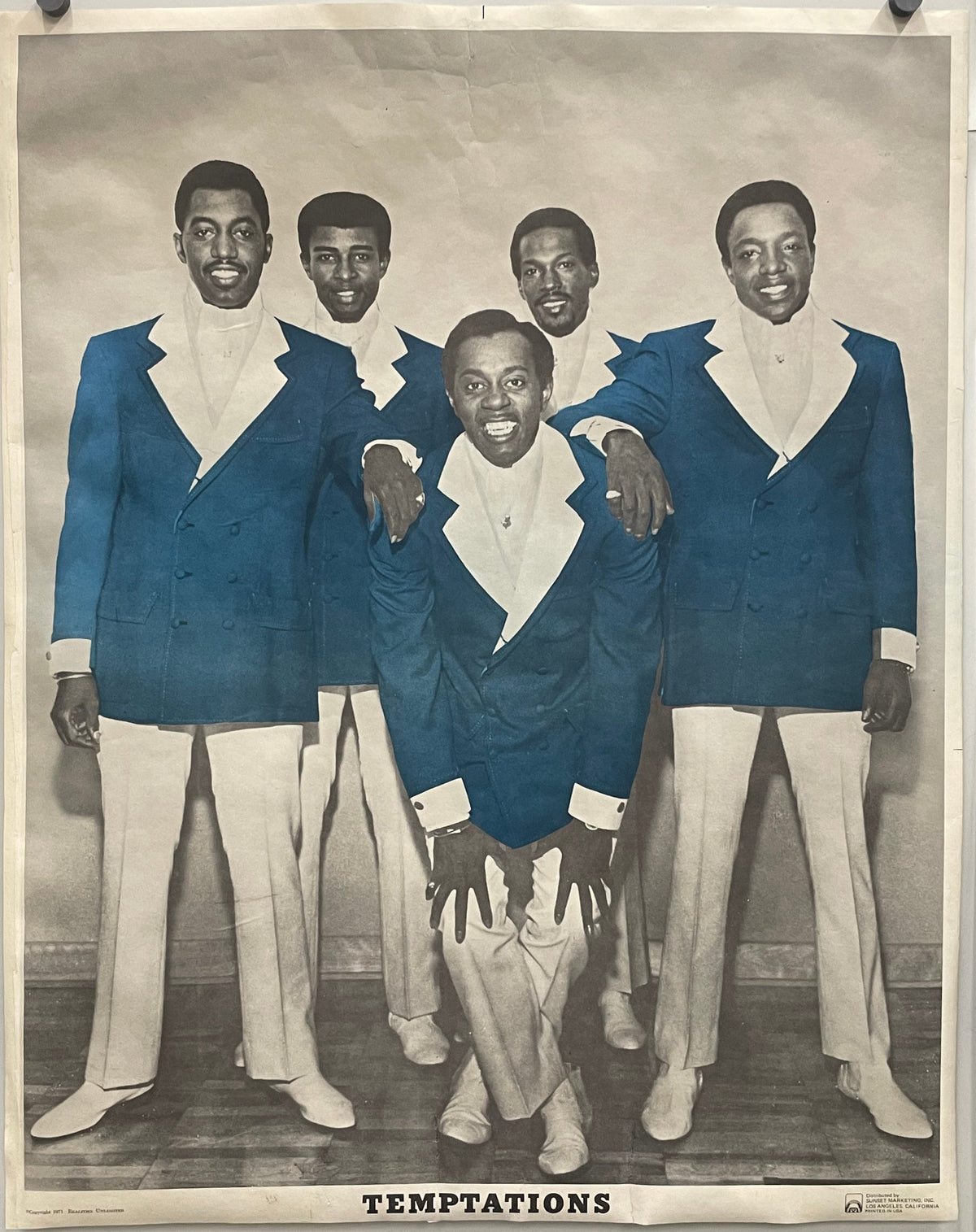 Vintage photograph of a group of men in suits with 'The Temptations' text, 1971