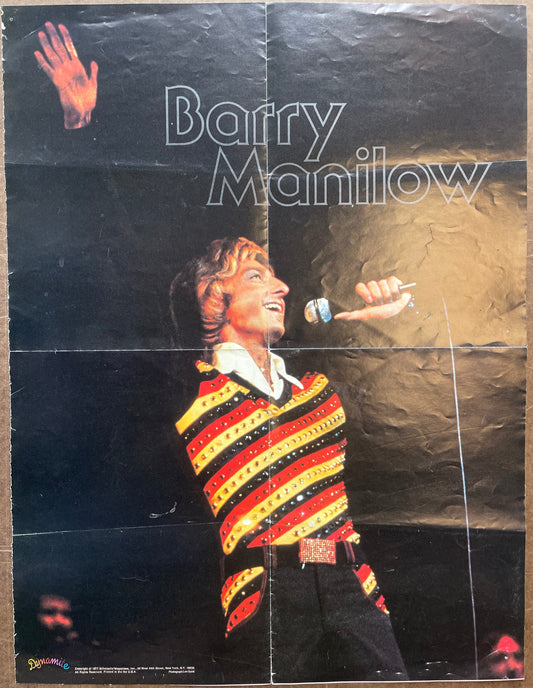 Poster of Barry Manilow with a colorful sweater on a dark background