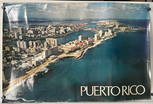 Inviting aerial view of the island’s rich green-blue waters and white sandy beaches in this beach resort vacation poster.