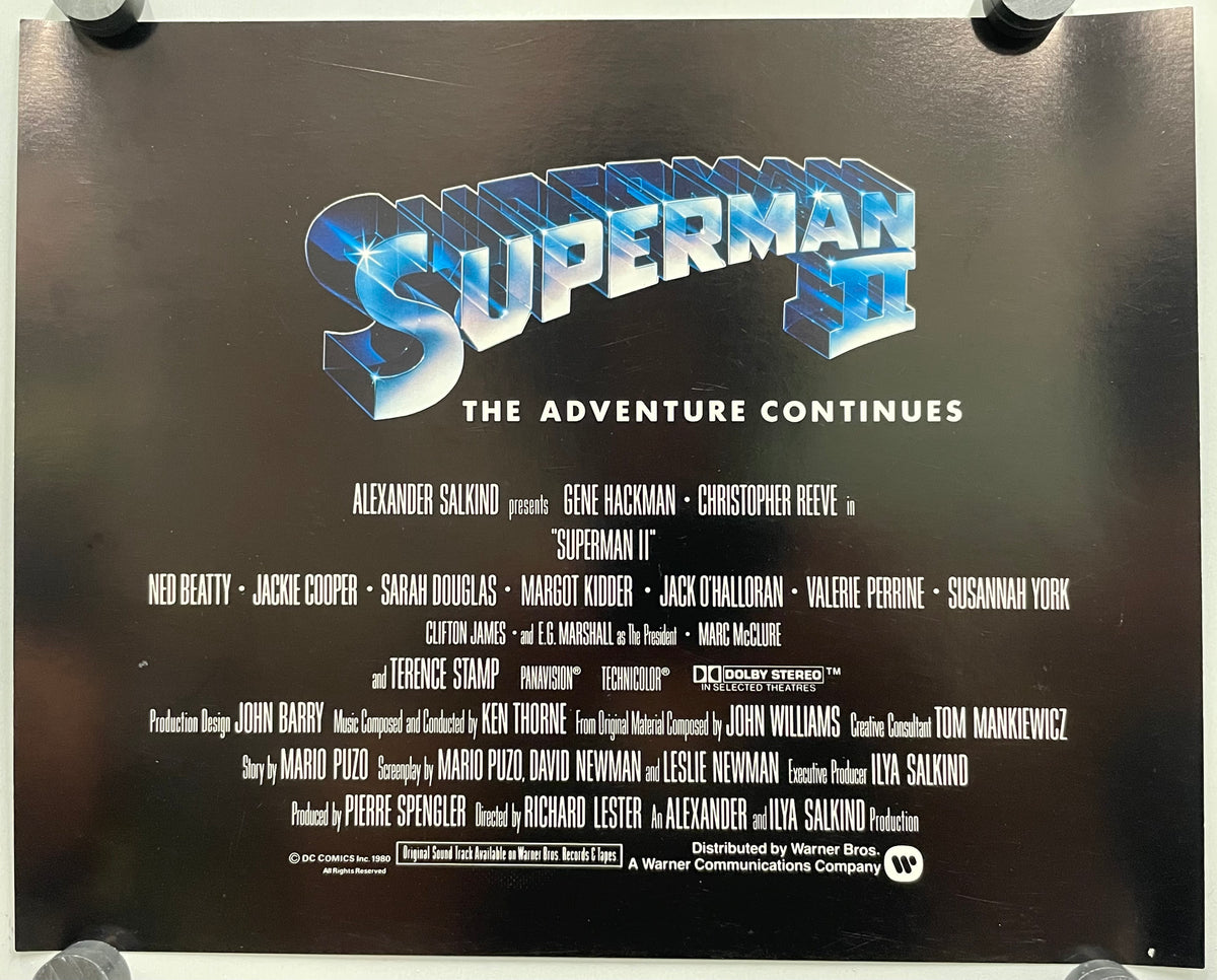 Superman movie poster with title and cast list on a black background