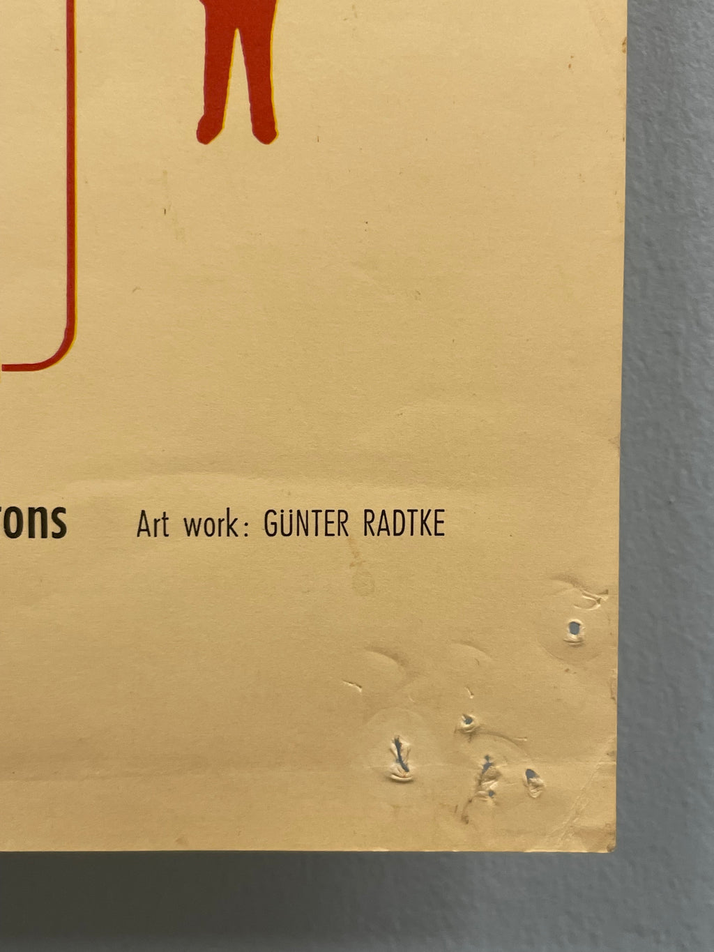 Beige product packaging with text and a logo on a gray background
