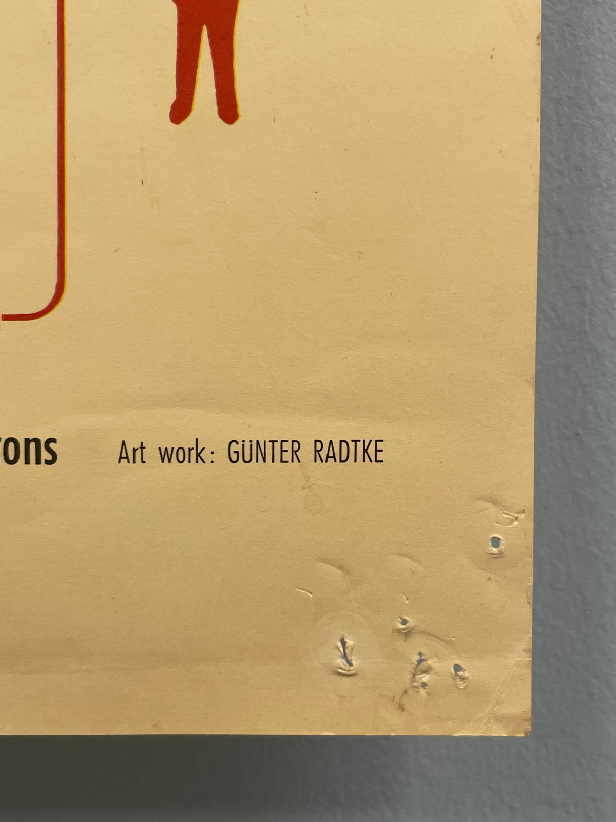 Beige product packaging with text and a logo on a gray background