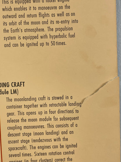 Text on a piece of brown paper with a crease