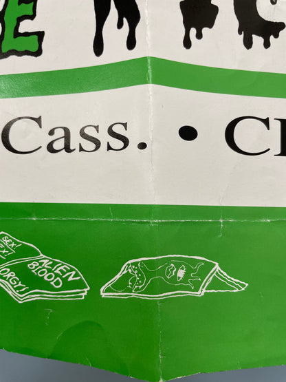 Green and white product packaging with text and illustrations on a gray background