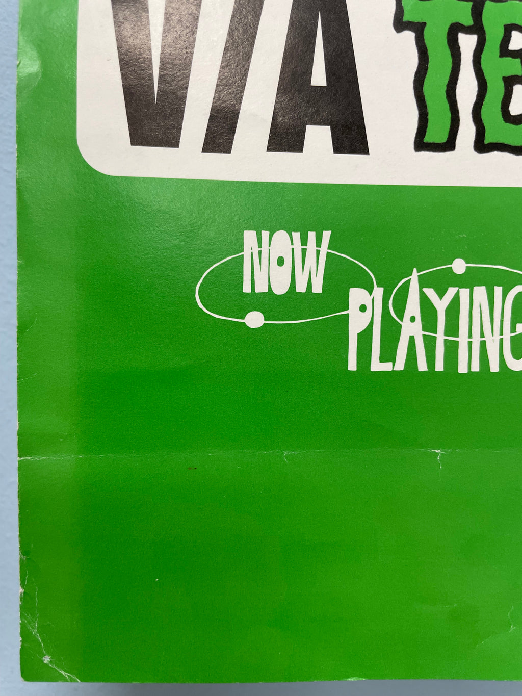 Close-up of a green vinyl record sleeve with text