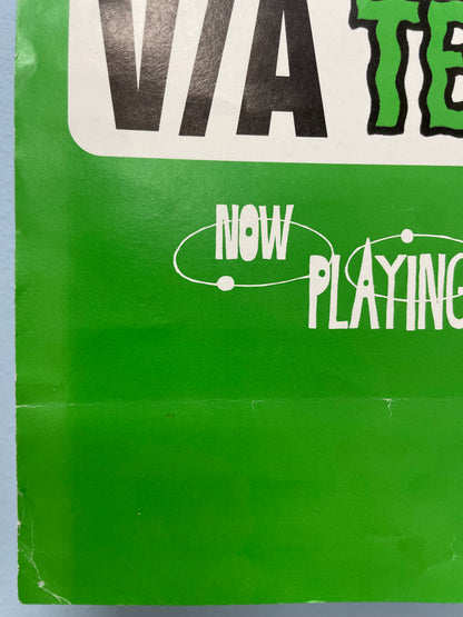 Close-up of a green vinyl record sleeve with text