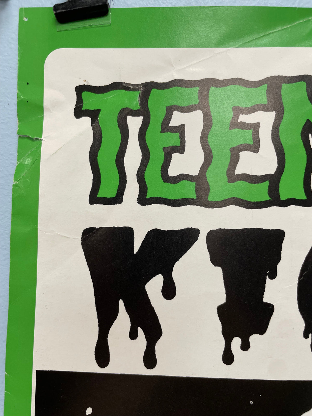Sticker with green and black text on a white background