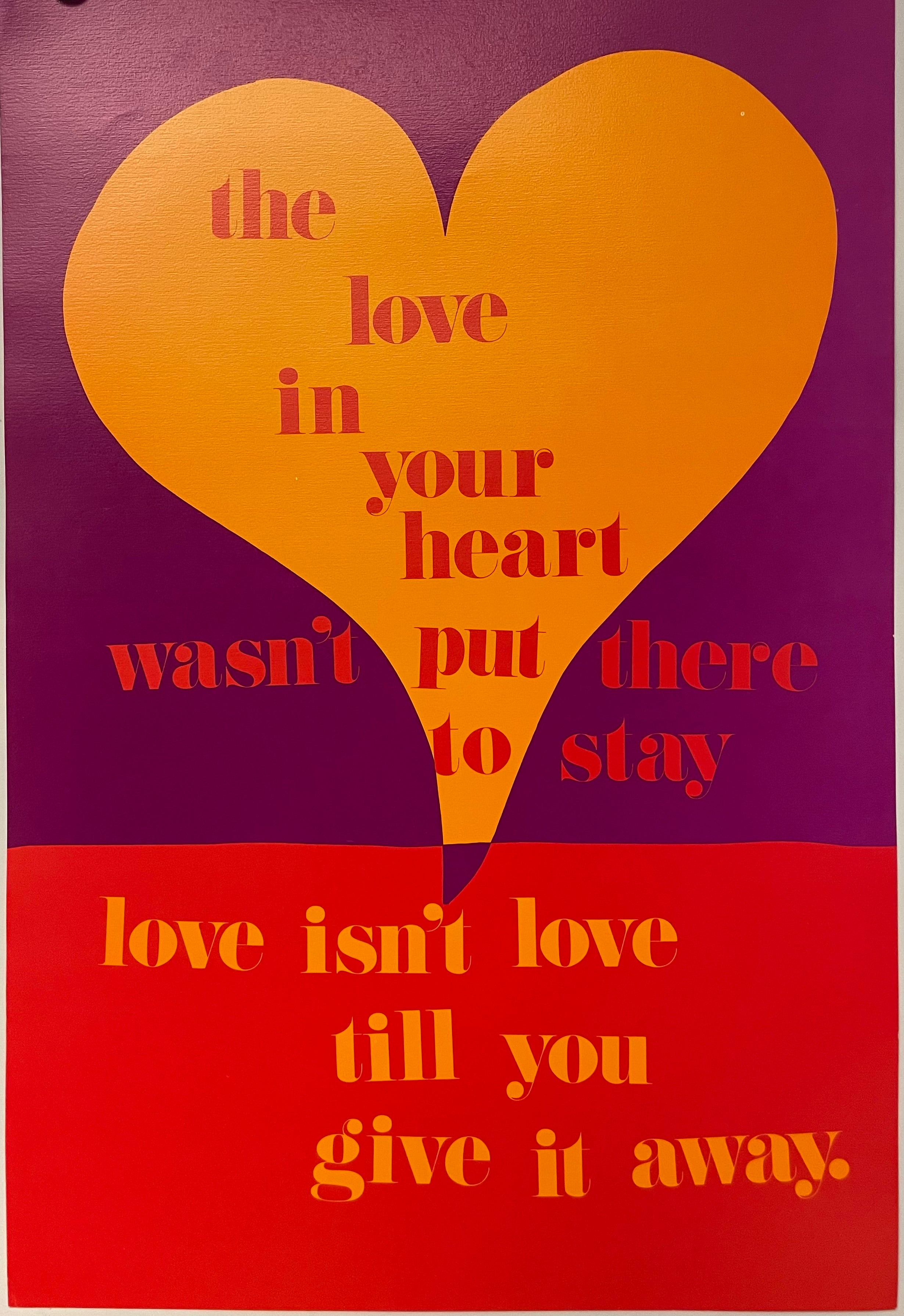 A vintage poster featuring a red and purple background with the text 'THE LOVE IN YOUR HEART WASN'T PUT THERE TO STAY' in orange and 'LOVE ISN'T LOVE UNTIL YOU GIVE IT AWAY' in yellow. The poster has a heart-shaped design in the background with a line drawing of a heart in the center.