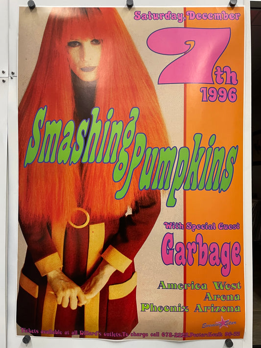 Promotional poster for a concert featuring Garbage and Smashing Pumpkins, with a stylized image of a person with red hair and a bow.