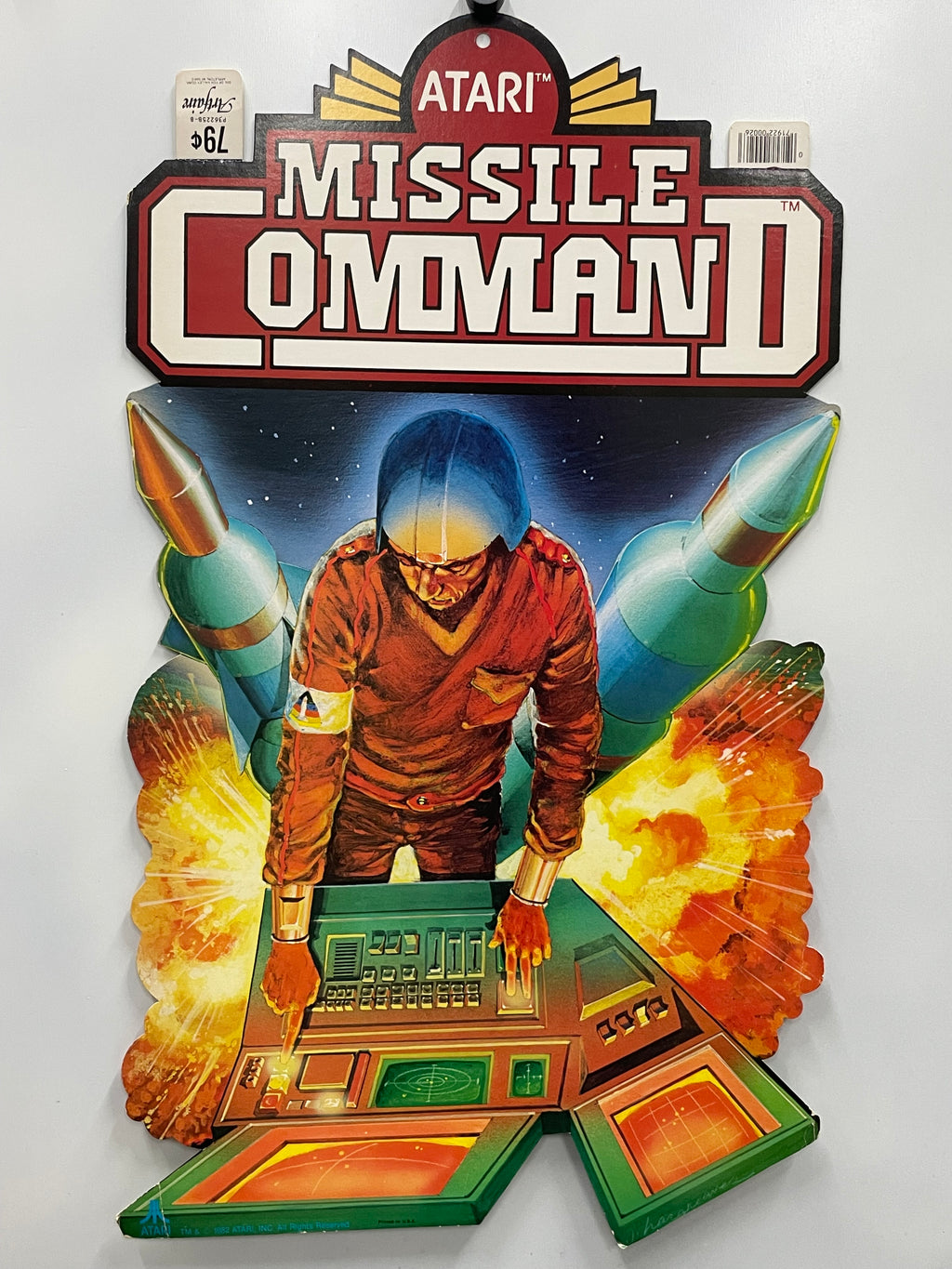 Vintage Atari Missile Command II game box with a character and rockets on a white background
