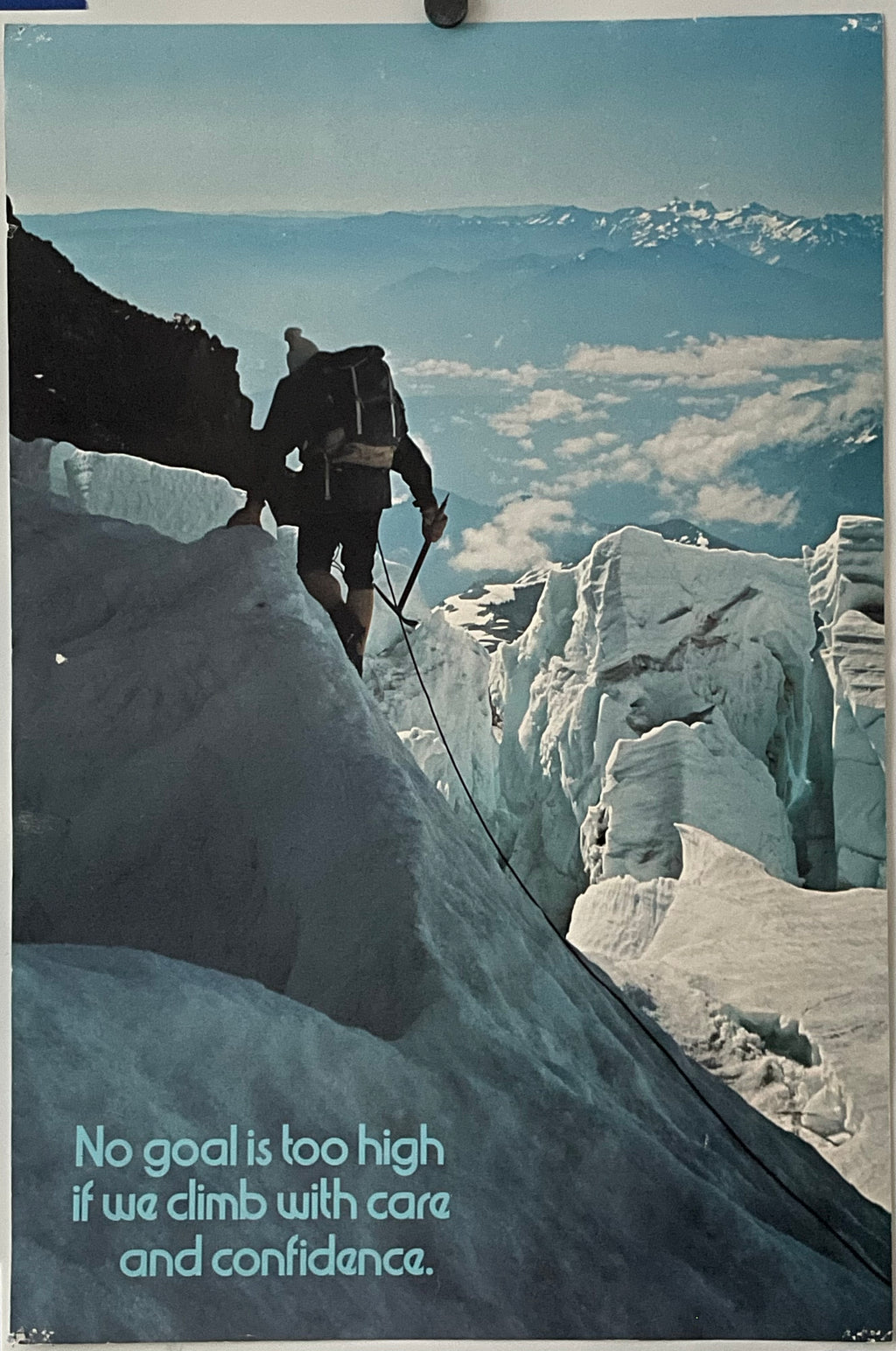 Vintage poster featuring a climber on a snowy mountain with a quote 'No goal is too high if we climb with care and confidence'.