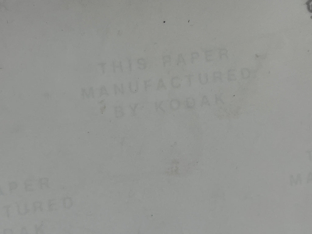 Off-white background with text 'THIS PAPER MANUFACTURED BY KODAK' 