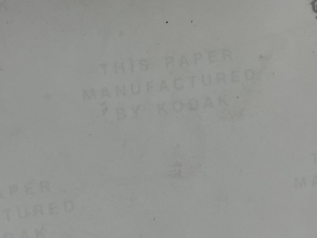Off-white background with text 'THIS PAPER MANUFACTURED BY KODAK' 