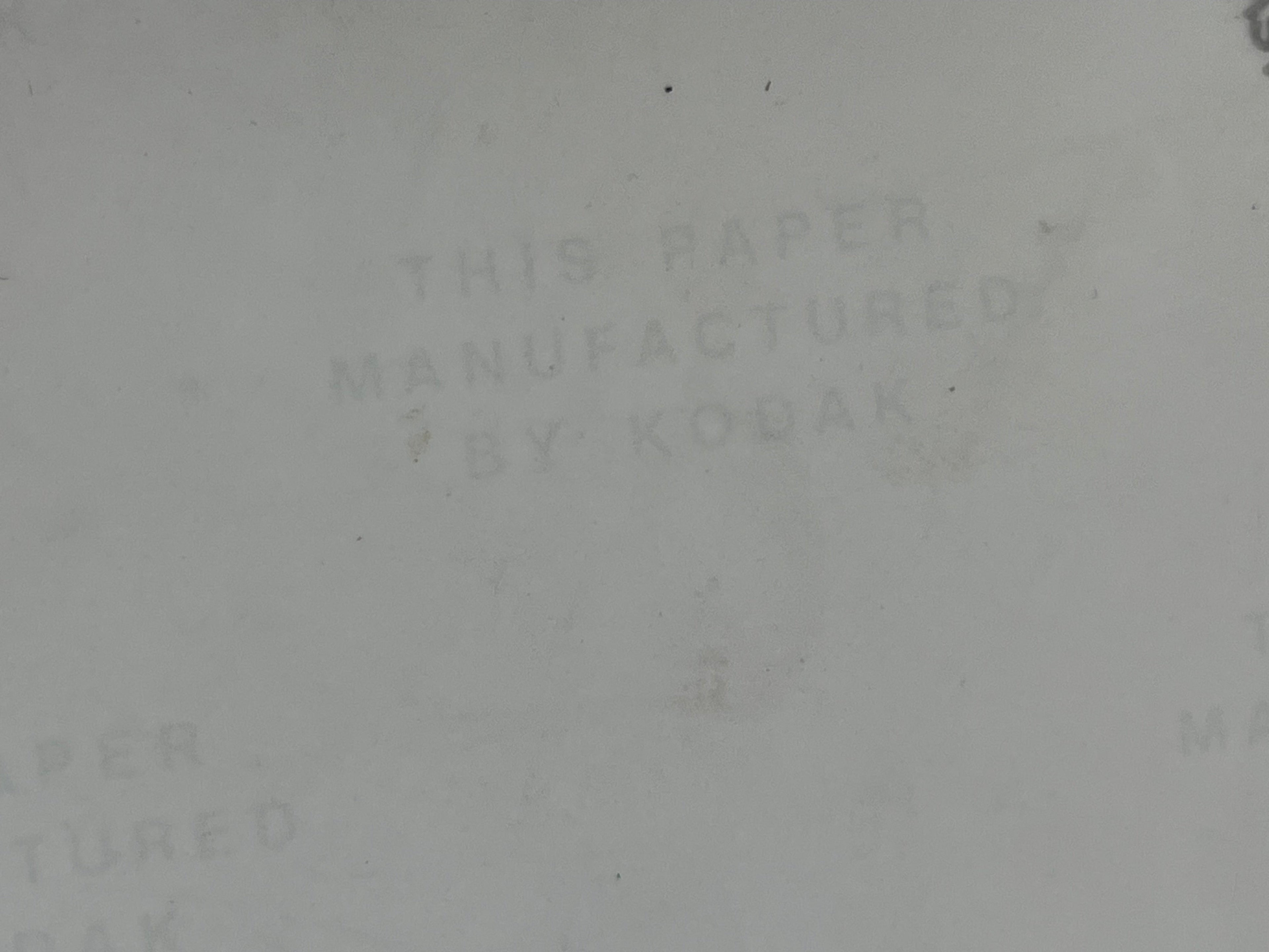 Off-white background with text 'THIS PAPER MANUFACTURED BY KODAK' 