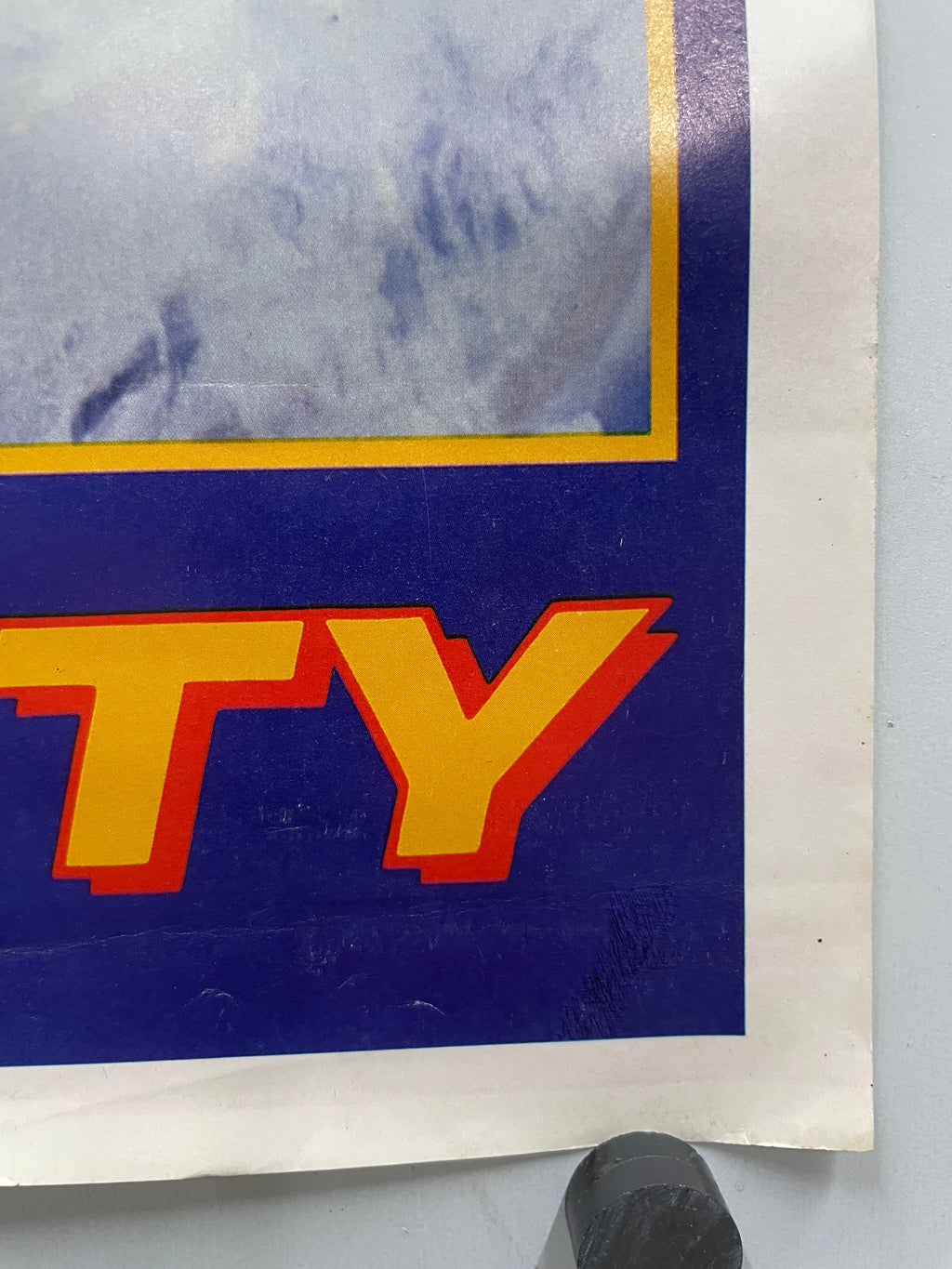 Close-up of the last two letters of the title text on a blue background.