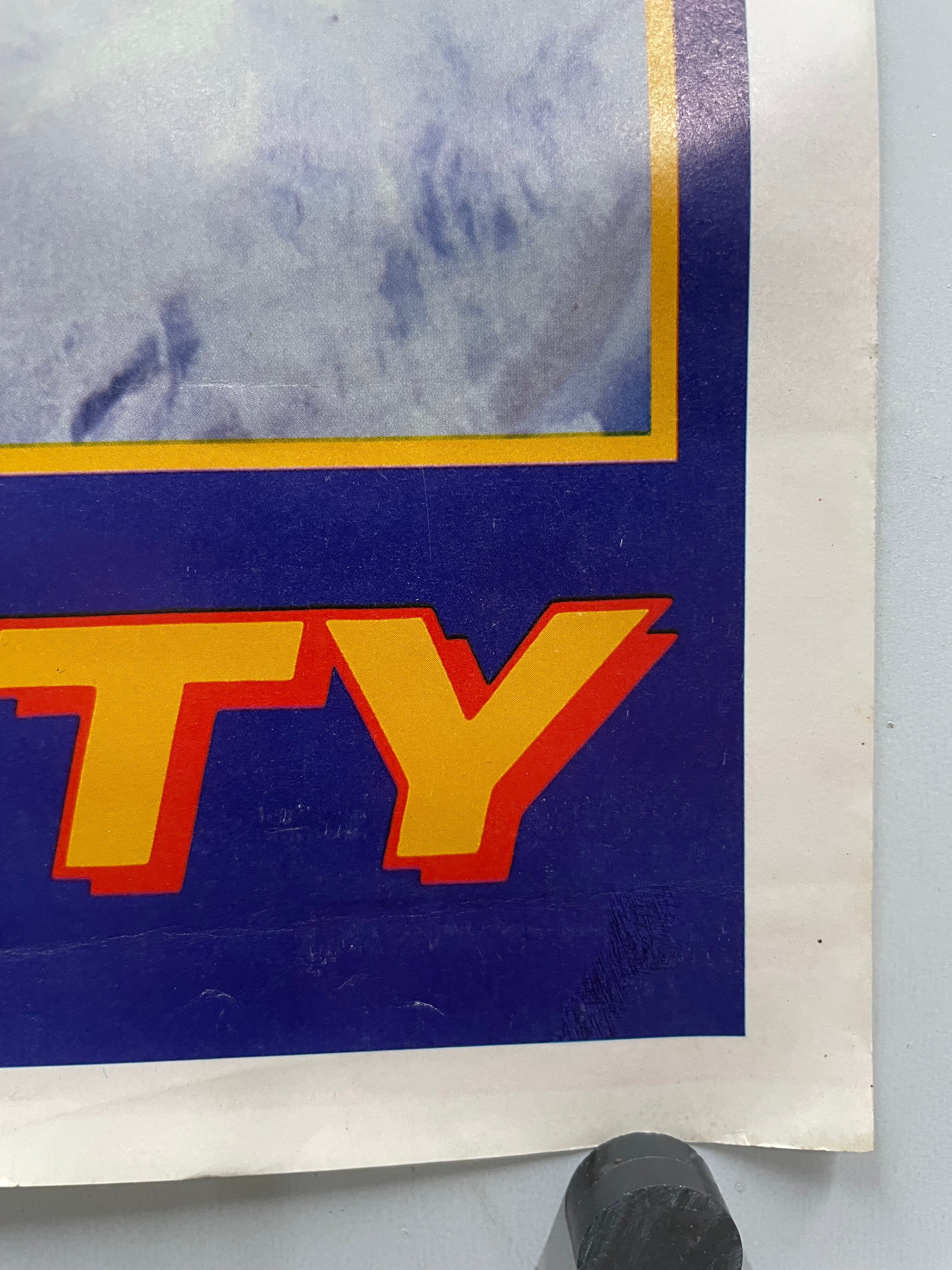 Close-up of the last two letters of the title text on a blue background.