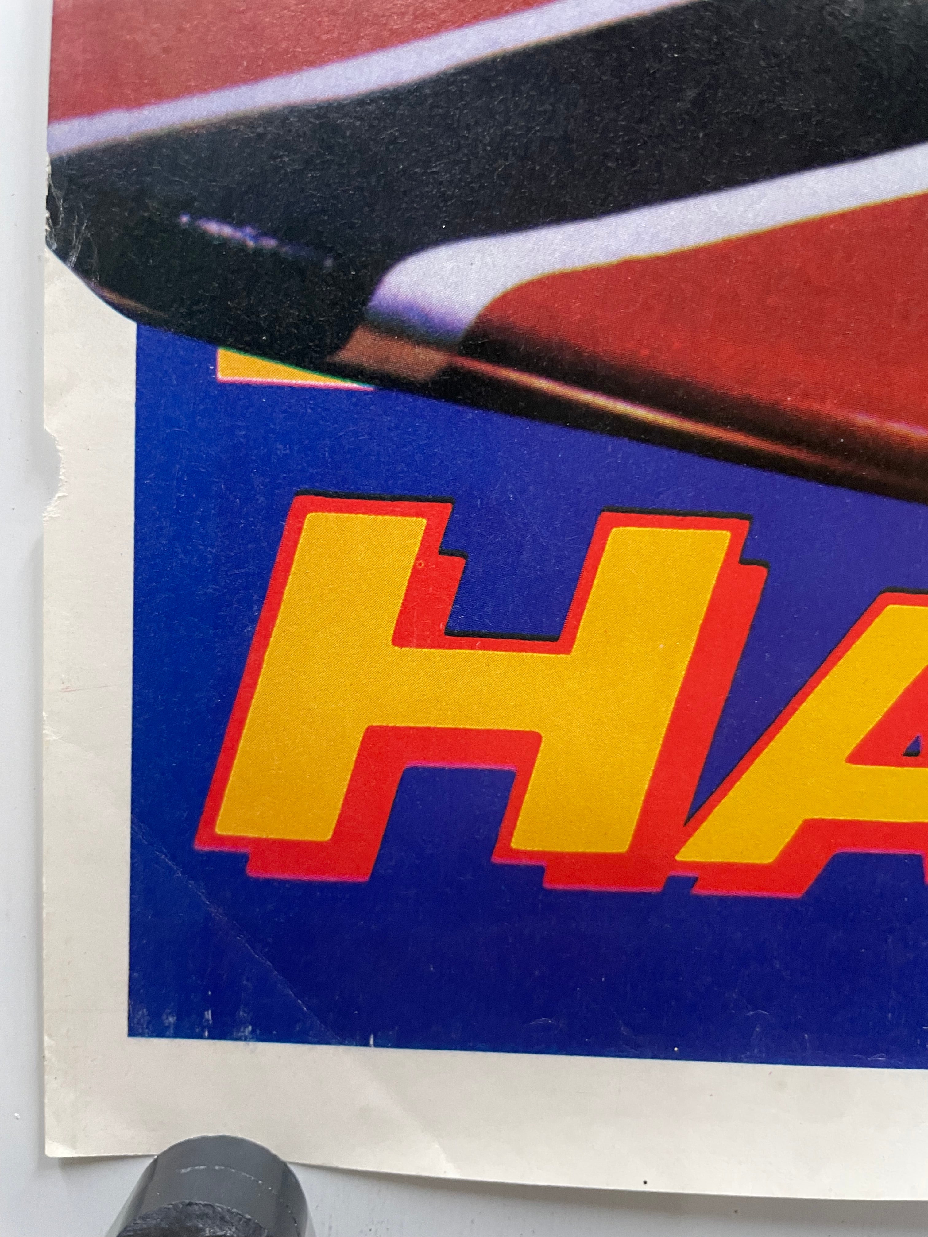 Close-up of a vintage poster with a portion of the graphic and  text on a blue background.