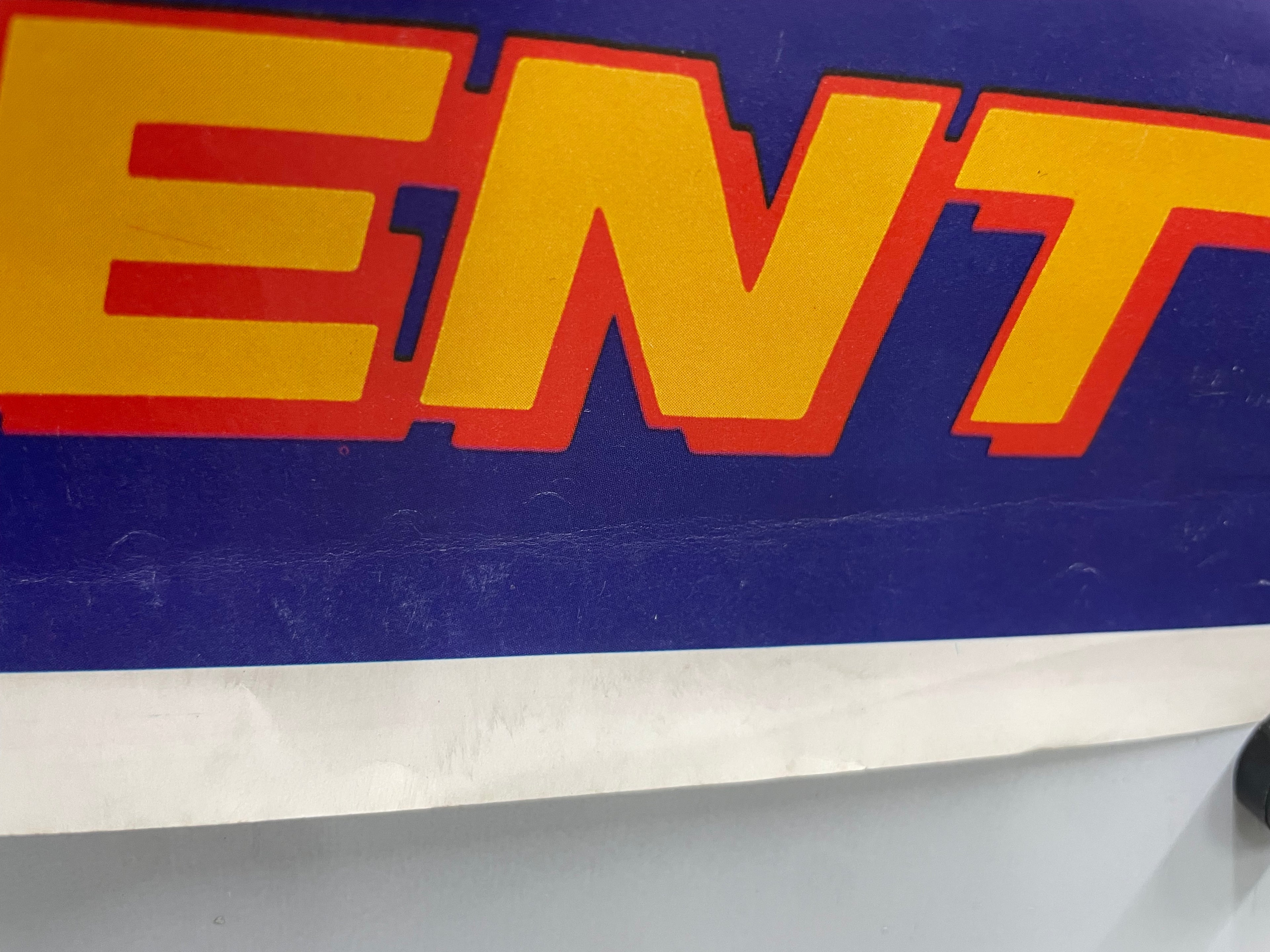 Close-up of letters from the title text on a blue background.