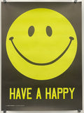 A black poster featuring a large yellow smiley face and the words 'HAVE A HAPPY' in yellow, hung with visible wall anchors.