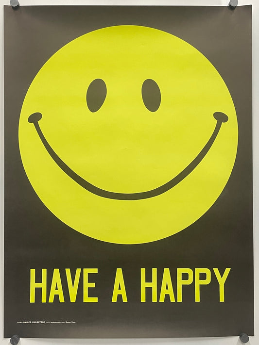 A black poster featuring a large yellow smiley face and the words 'HAVE A HAPPY' in yellow, hung with visible wall anchors.
