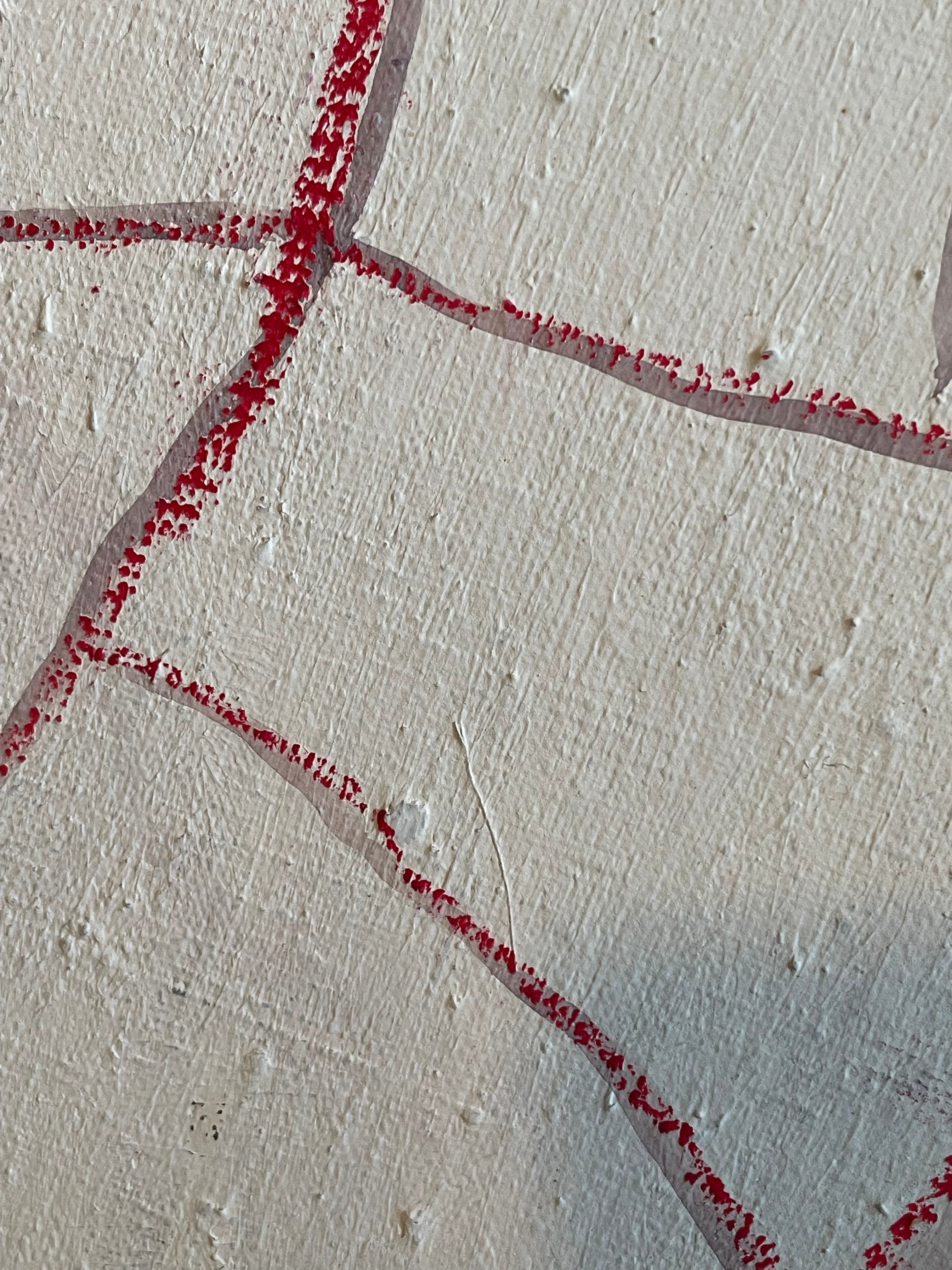 A close-up of a textured off-white surface with a red dotted line pattern forming geometric shapes.