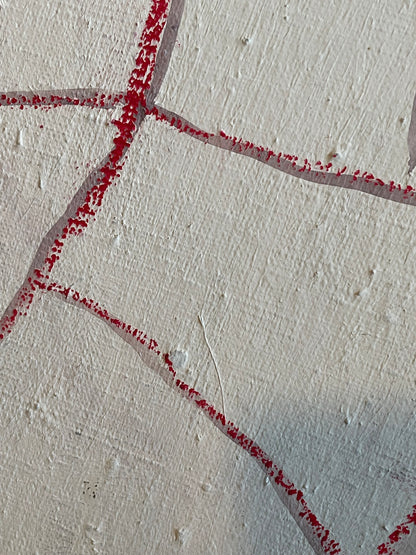 A close-up of a textured off-white surface with a red dotted line pattern forming geometric shapes.